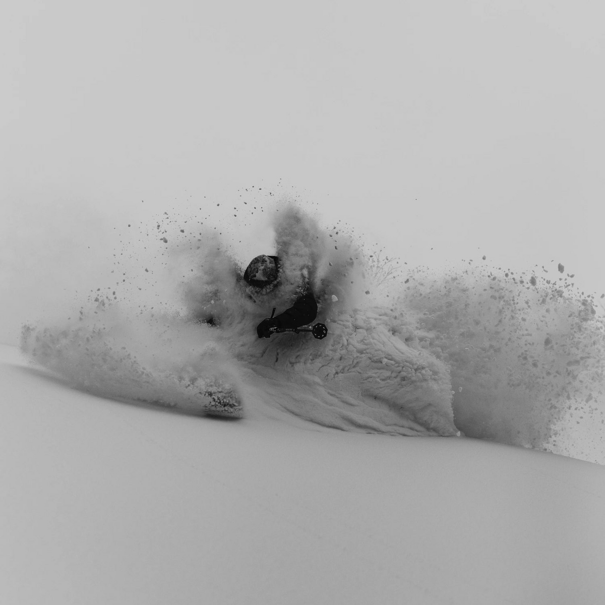A skier carving though powder conditions